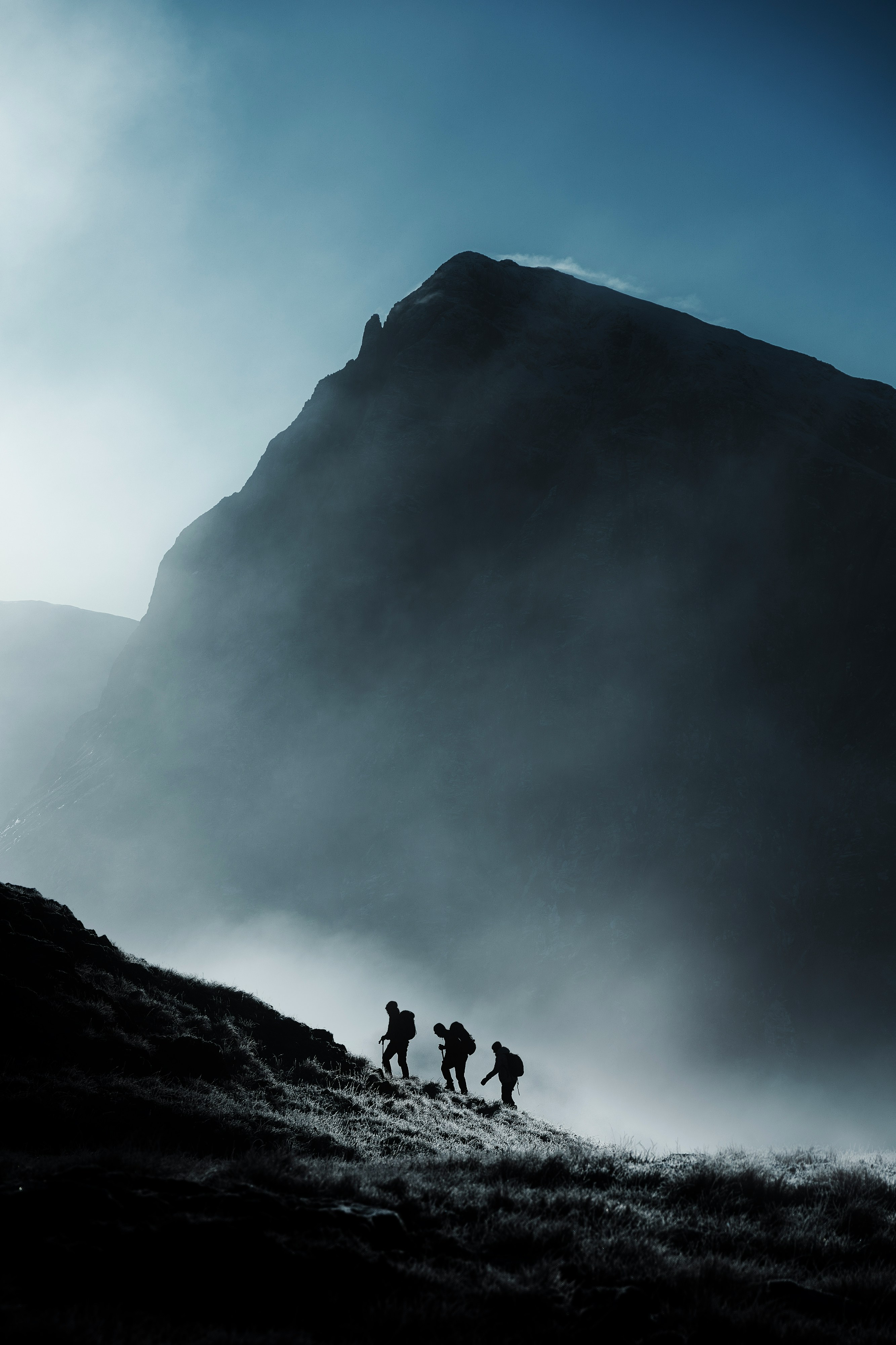 Group climbing through mist together